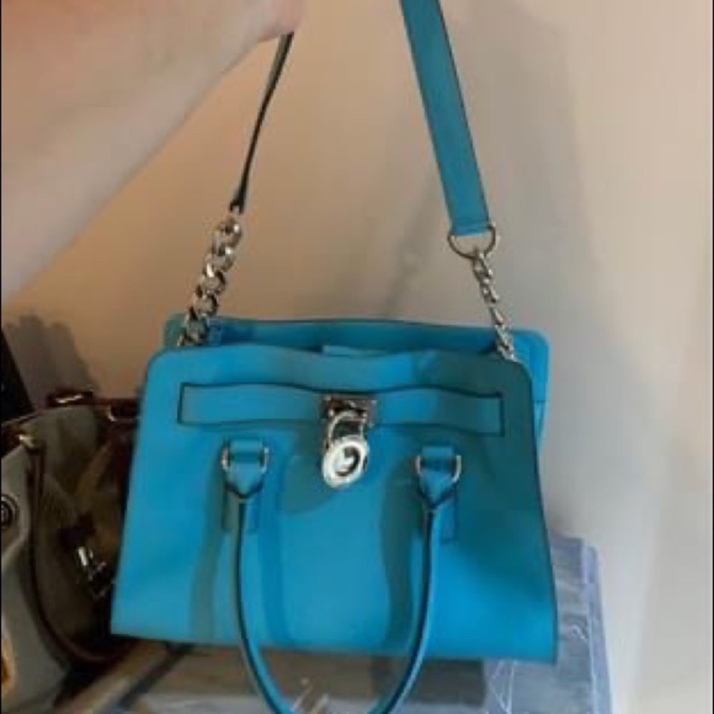 Turquoise Michael Kors handbag.